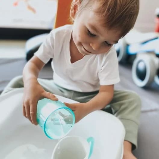 Toddler pouring water