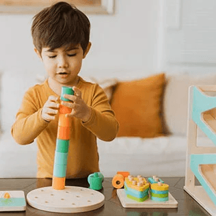 Child playing with toys from Lovevery